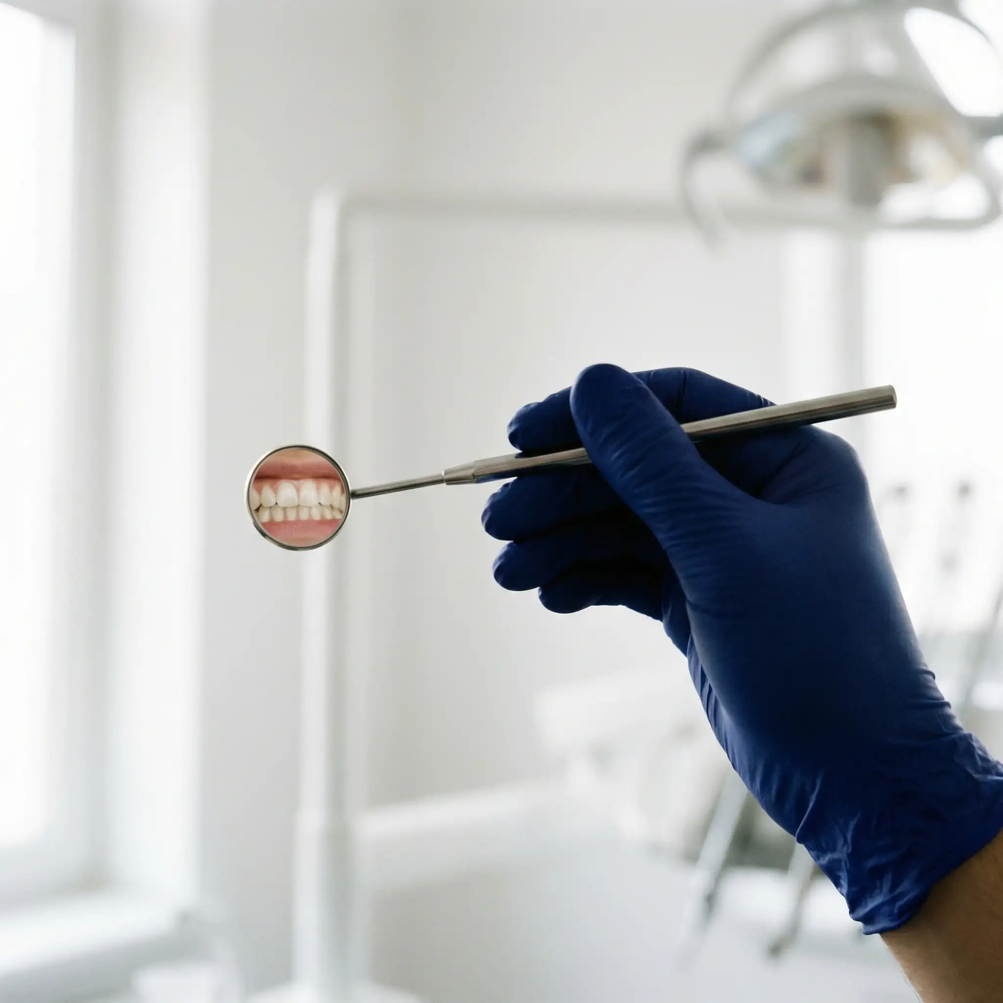 Close-up of a dentist holding a porcelain veneer with precision