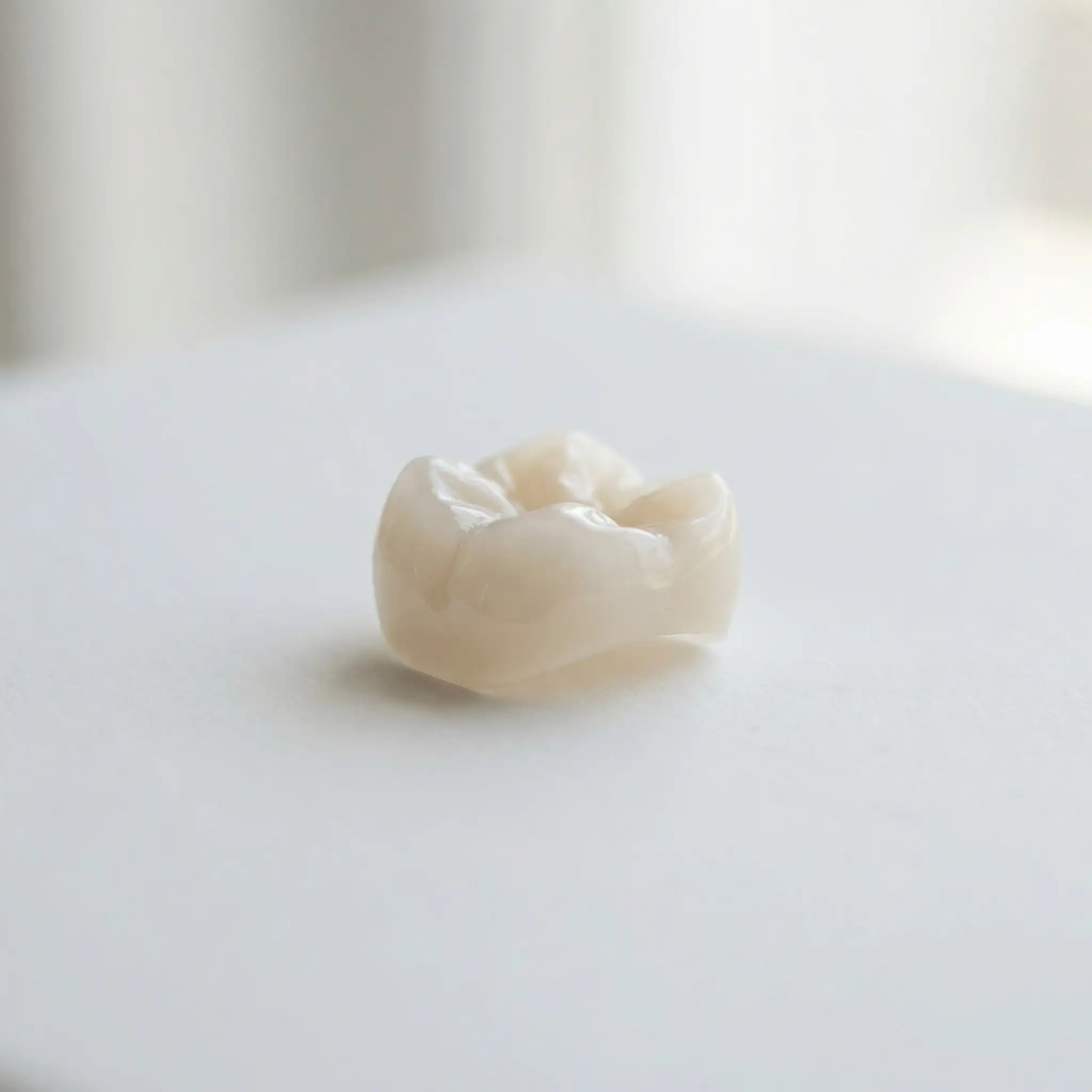 Macro photograph of a crafted ceramic dental crown